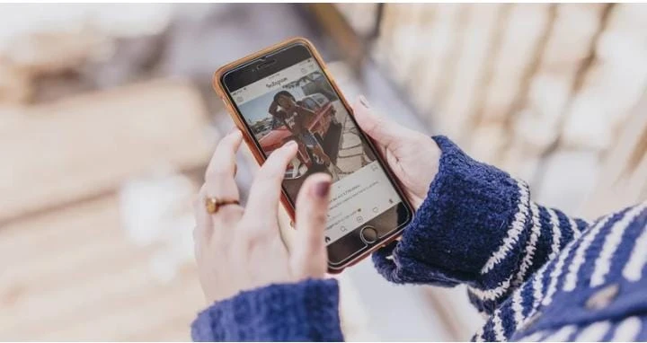 Caption for Instagram shown through a person composing social media text on a smartphone